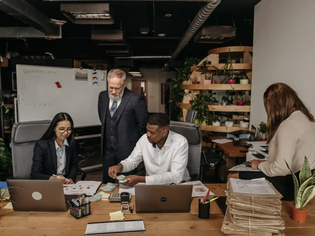 Team of professionals working together in an office, highlighting collaboration and growth in insurance careers.